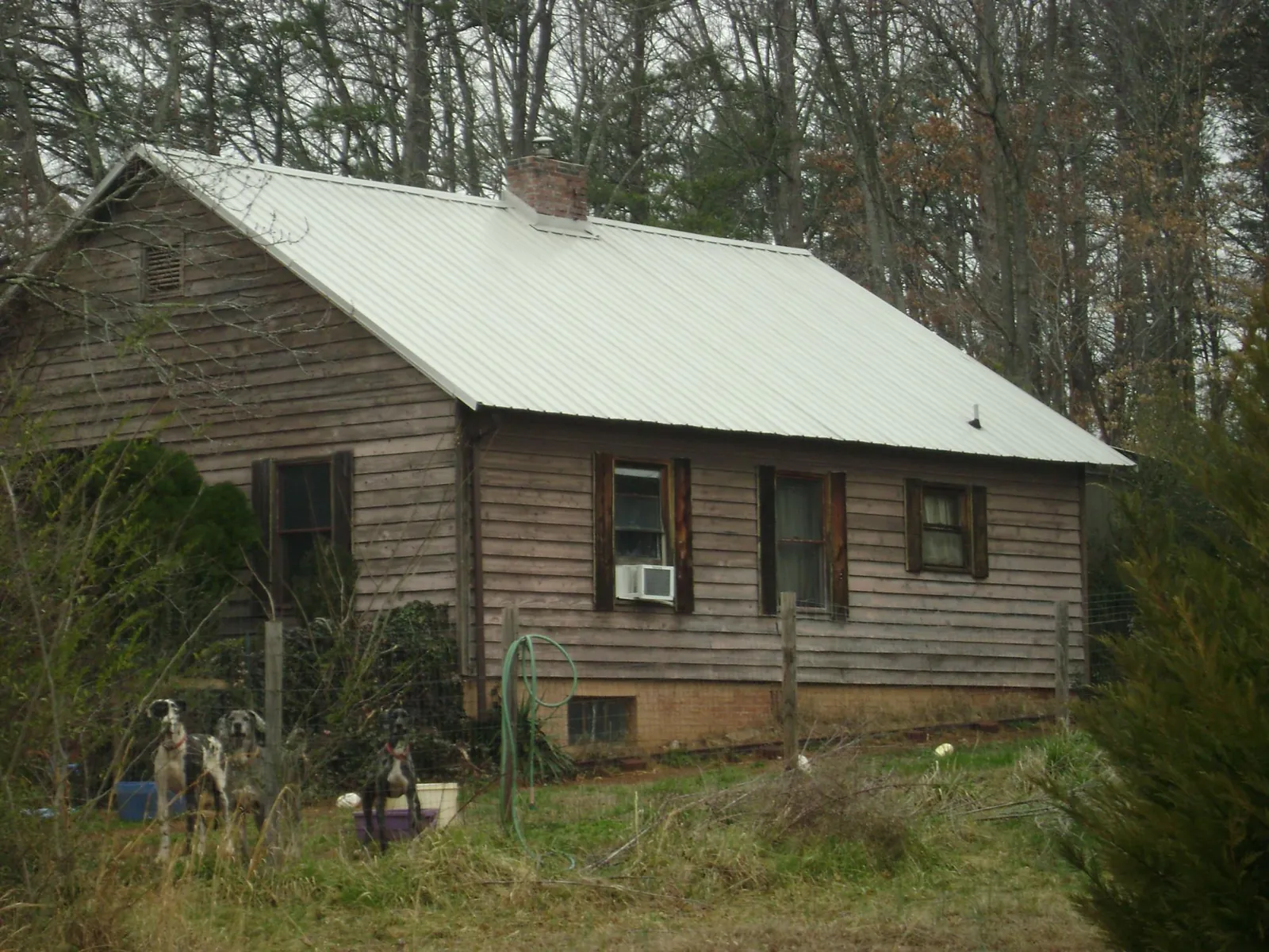 White metal roof on an old wood sided farmhouse, from a Metal Roof Installation job in Oquawka